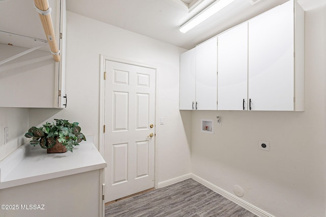 clothes washing area with light hardwood / wood-style floors, electric dryer hookup, hookup for a washing machine, cabinets, and gas dryer hookup