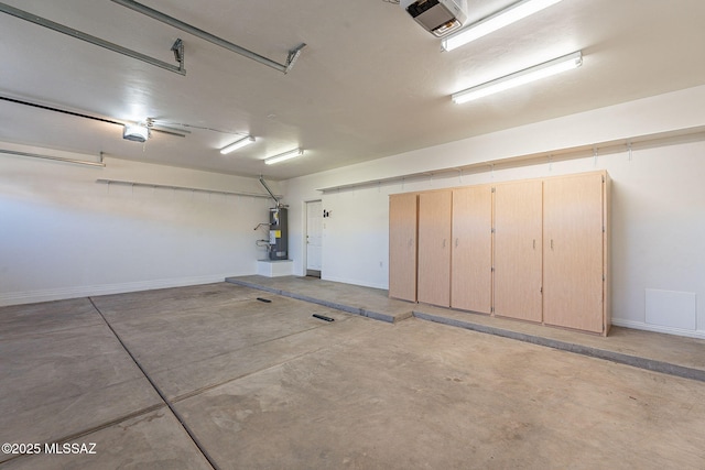 garage featuring water heater and a garage door opener