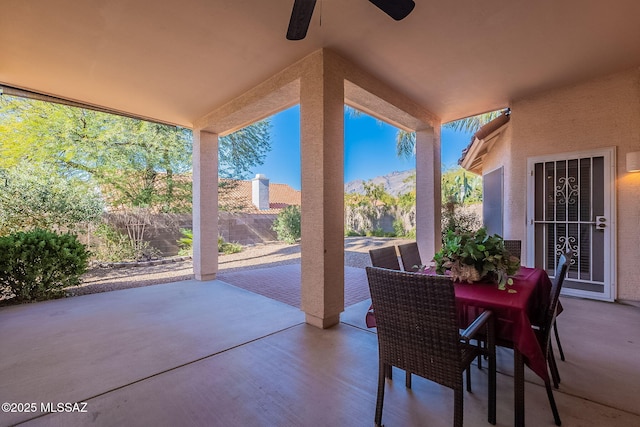 view of patio / terrace with ceiling fan and a mountain view