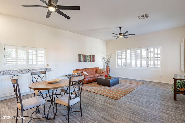 bedroom featuring ceiling fan, dark wood-type flooring, and high vaulted ceiling