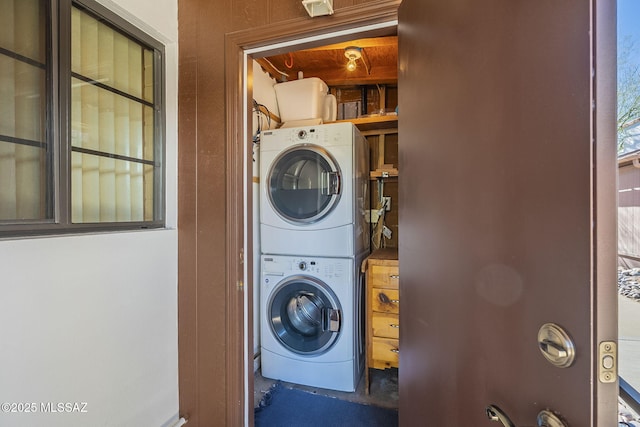 laundry area with stacked washer and clothes dryer and laundry area