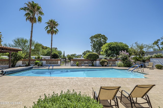 pool with fence and a patio area