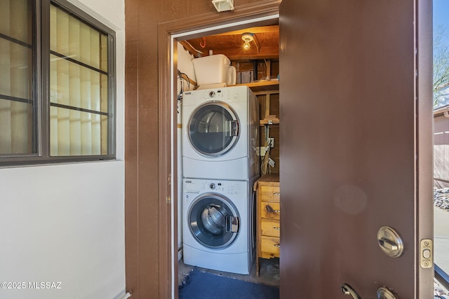 laundry room with laundry area and stacked washer and clothes dryer