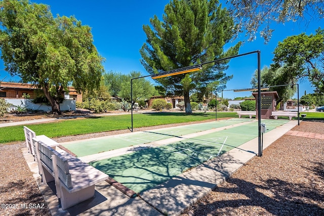 view of basketball court with a yard