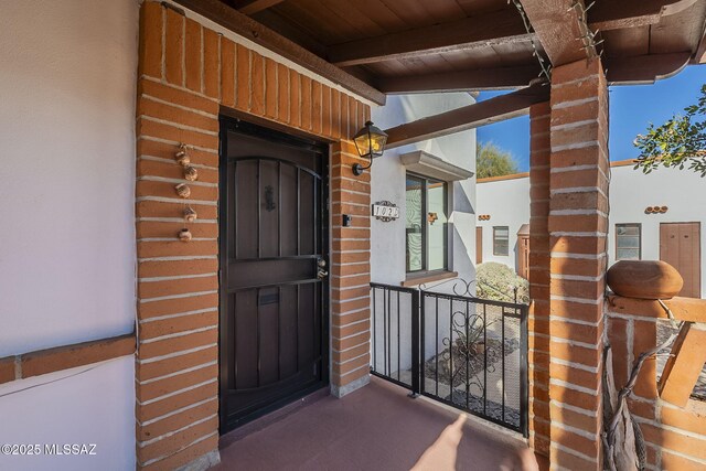 view of exterior entry featuring a balcony