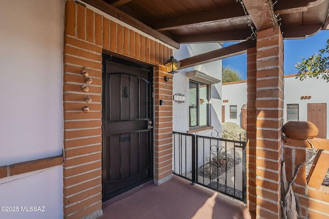 doorway to property featuring brick siding