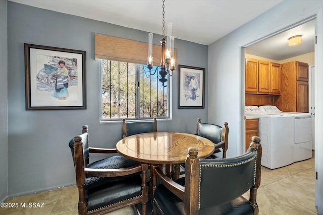 tiled dining space featuring an inviting chandelier and separate washer and dryer