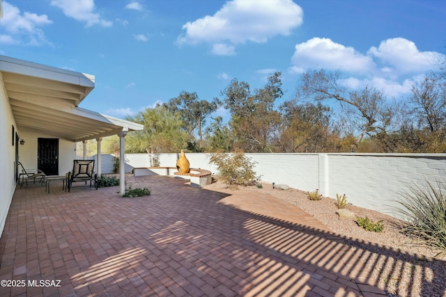 view of patio with an outdoor fire pit