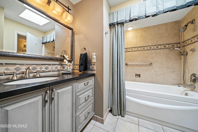 bathroom featuring decorative backsplash, tile patterned floors, a skylight, shower / bath combo with shower curtain, and vanity