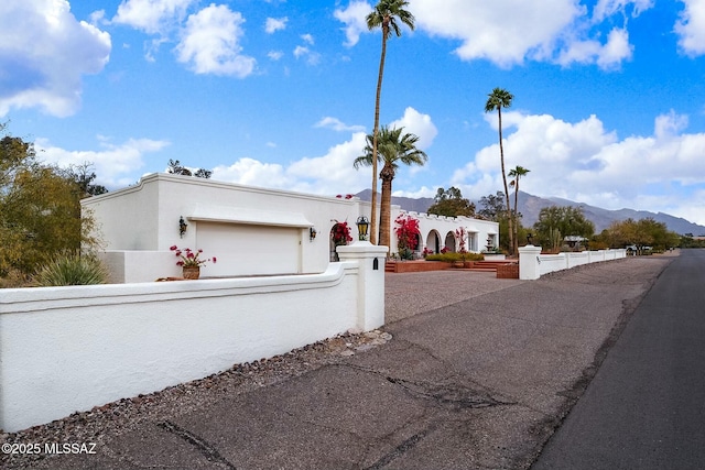 view of front of house with a garage and a mountain view