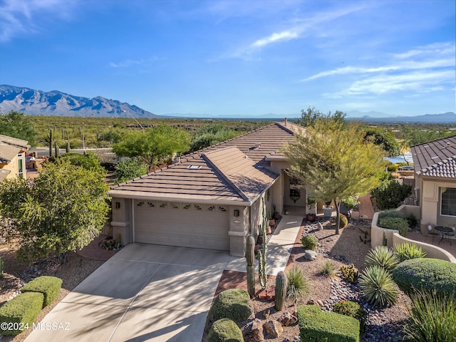 view of front facade featuring a mountain view and a garage