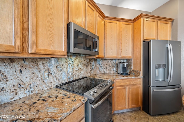 kitchen featuring light tile patterned floors, backsplash, light stone counters, and stainless steel appliances