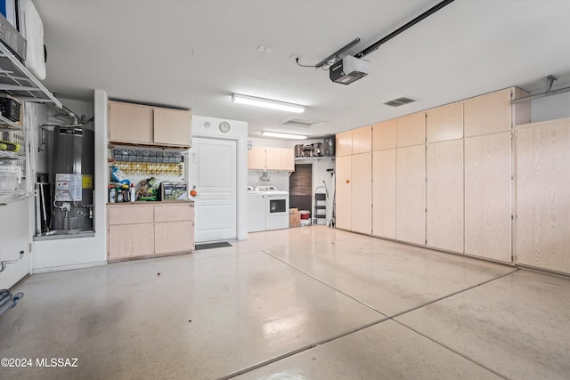 garage featuring a garage door opener, washer and dryer, and gas water heater