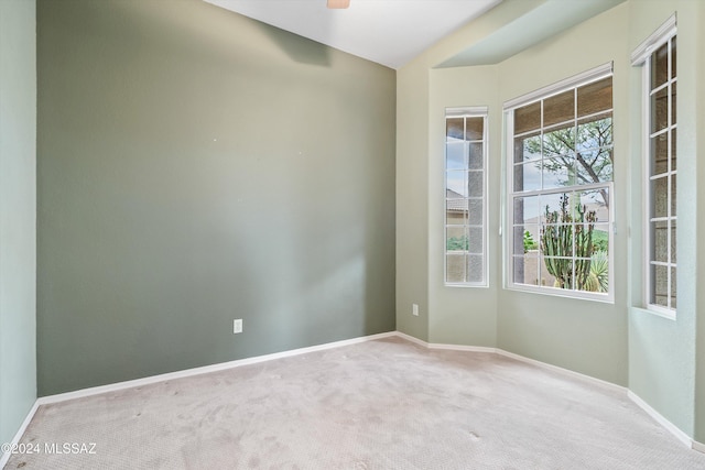 empty room with ceiling fan and carpet flooring