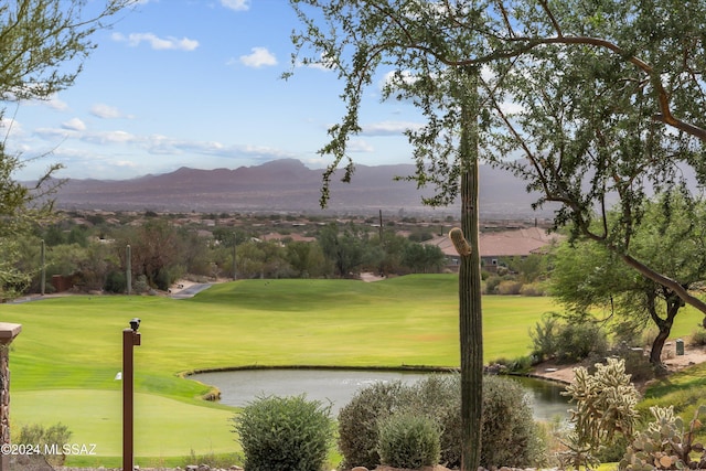 view of home's community featuring a water and mountain view and a lawn