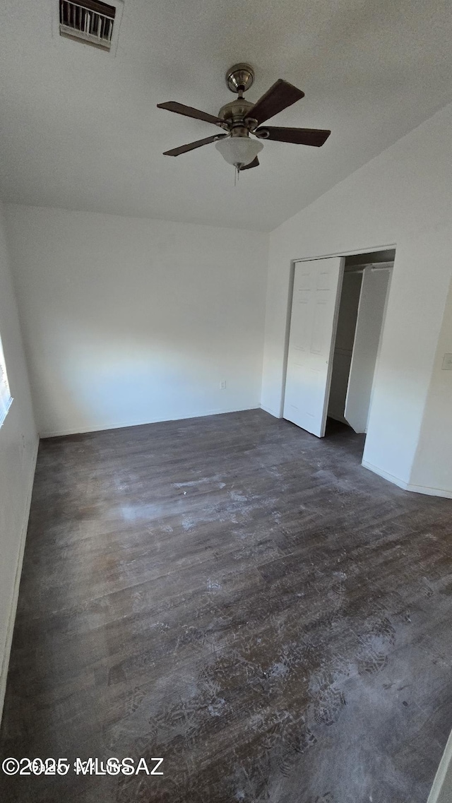 unfurnished bedroom with ceiling fan, lofted ceiling, and a closet