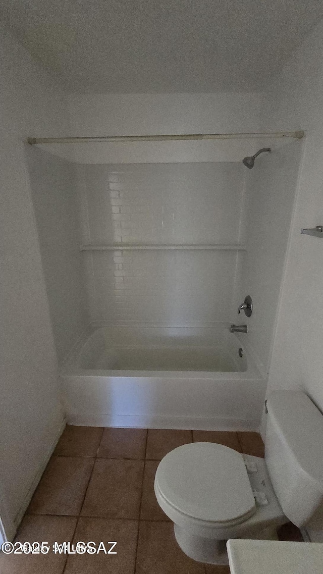 bathroom featuring tile patterned flooring, shower / bathtub combination, and toilet