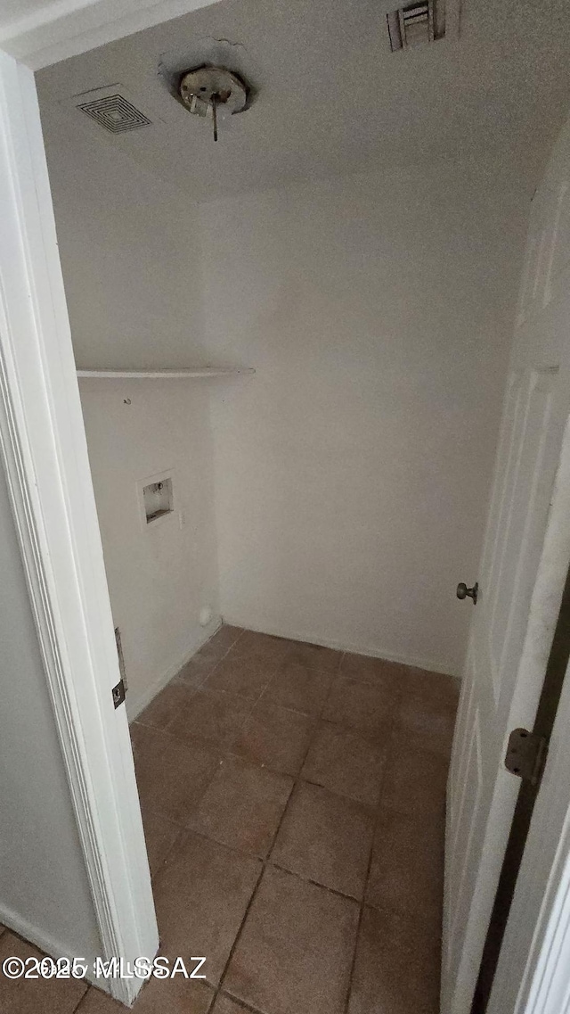 washroom with dark tile patterned floors