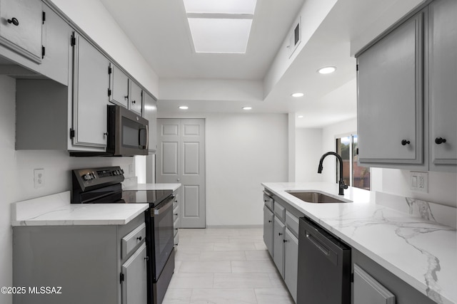 kitchen featuring sink, dishwasher, black electric range oven, and gray cabinets