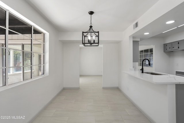 dining area with sink and an inviting chandelier