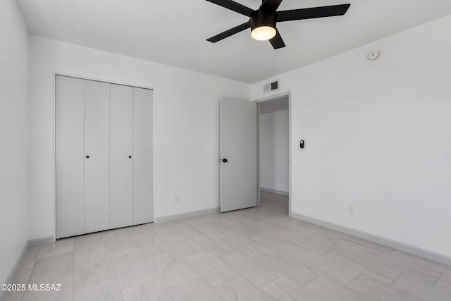 unfurnished bedroom featuring ceiling fan and a closet