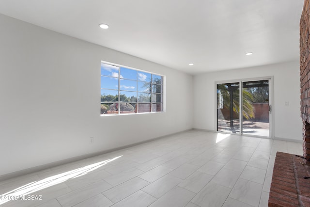 unfurnished room featuring plenty of natural light and light tile patterned floors