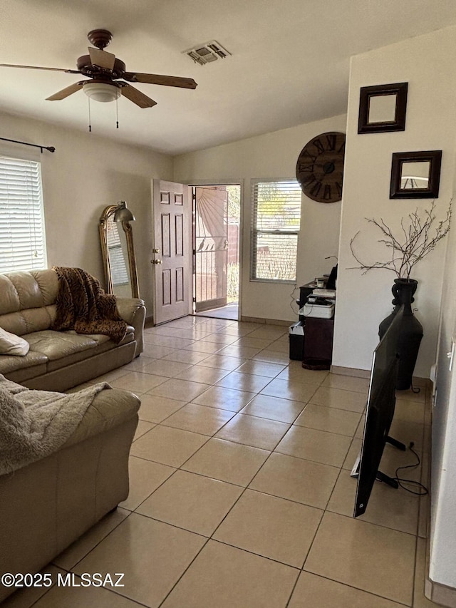 tiled living room featuring ceiling fan