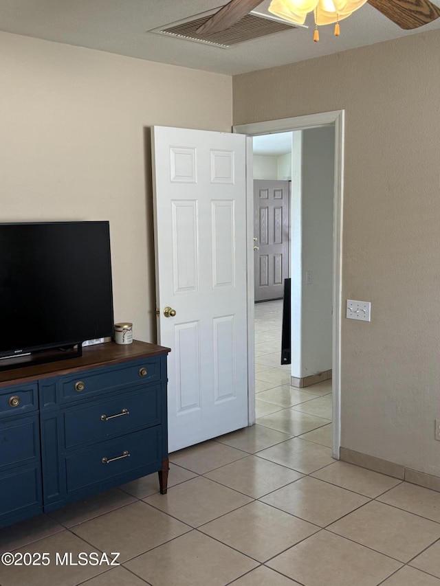 tiled bedroom featuring ceiling fan