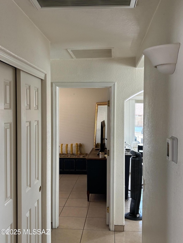 hall with light tile patterned floors