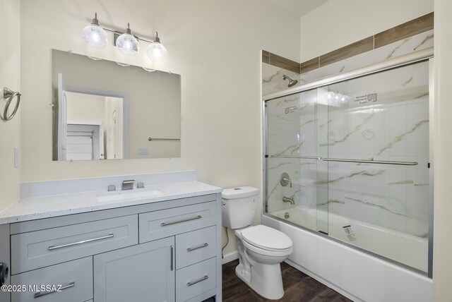 kitchen featuring sink, dark wood-type flooring, dishwasher, and light stone countertops