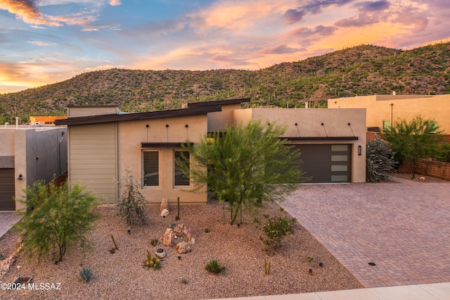 adobe home with a mountain view and a garage