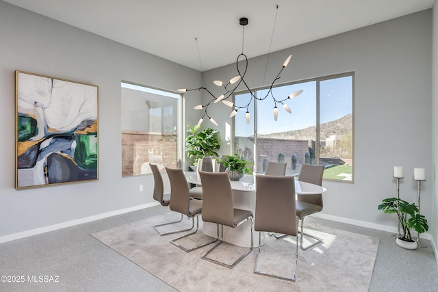 dining space with a mountain view and a notable chandelier