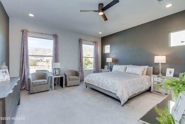 bedroom with ceiling fan and light carpet