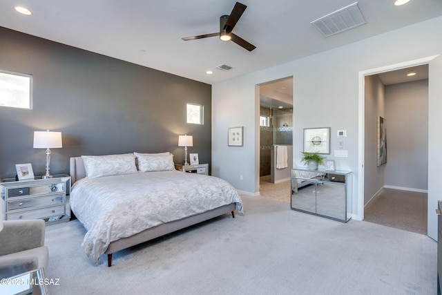 bedroom featuring ceiling fan, light colored carpet, and multiple windows