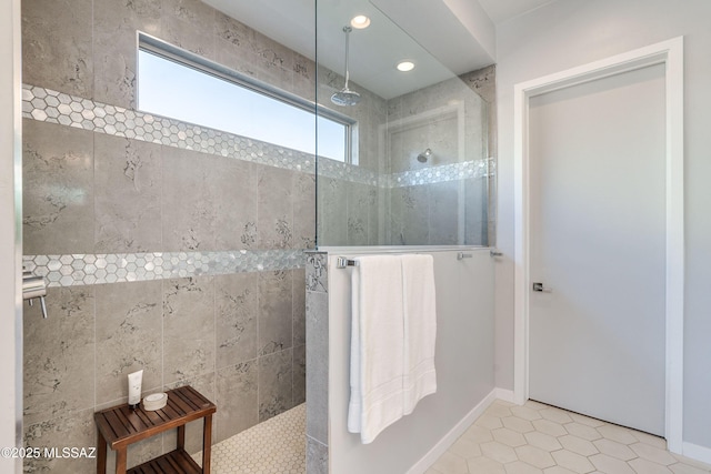 bathroom featuring tile patterned flooring and tiled shower