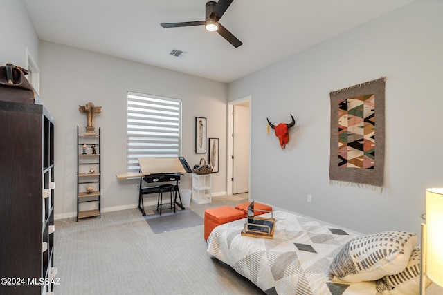 bedroom with ceiling fan and light carpet