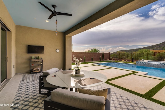 view of pool with a mountain view, an in ground hot tub, a patio, and pool water feature