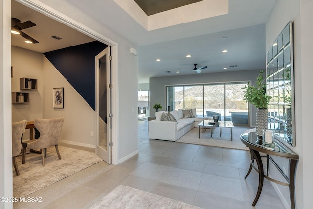 living room featuring light tile patterned floors and ceiling fan