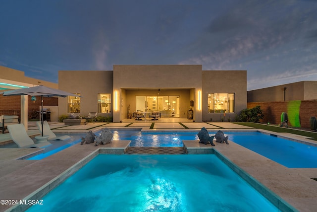 view of swimming pool featuring an in ground hot tub and a patio