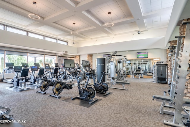 workout area with carpet floors, a high ceiling, and coffered ceiling