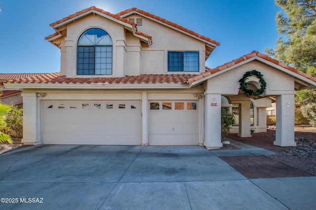 mediterranean / spanish home featuring a garage