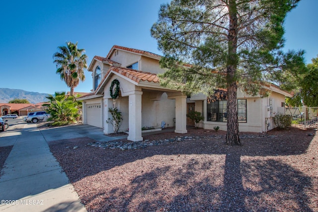 mediterranean / spanish-style home featuring a garage and a mountain view