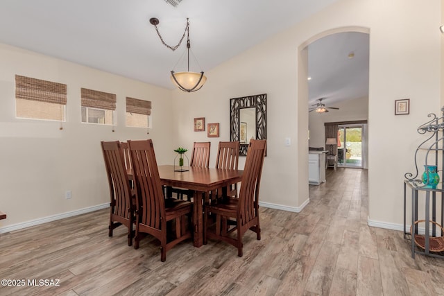 dining space with ceiling fan, light hardwood / wood-style flooring, and lofted ceiling