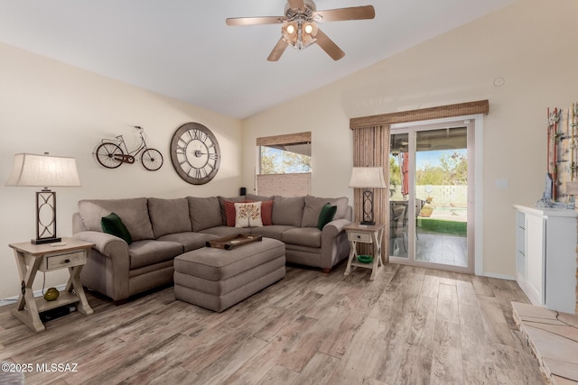 living room featuring lofted ceiling, ceiling fan, and light hardwood / wood-style floors