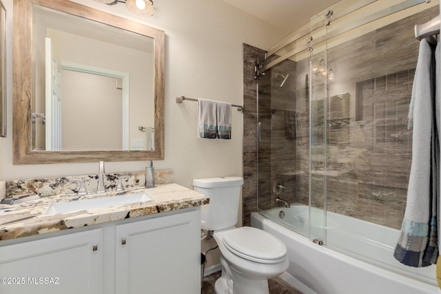 full bathroom with enclosed tub / shower combo, vanity, and toilet