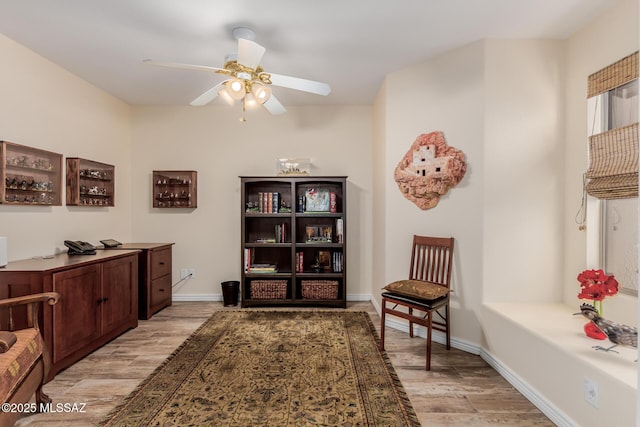 sitting room with ceiling fan and light hardwood / wood-style flooring