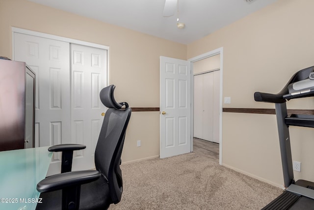 carpeted office featuring ceiling fan