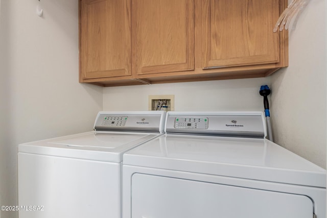 washroom featuring cabinets and independent washer and dryer