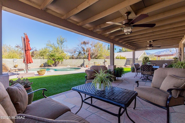 view of patio / terrace with ceiling fan, a fenced in pool, and outdoor lounge area