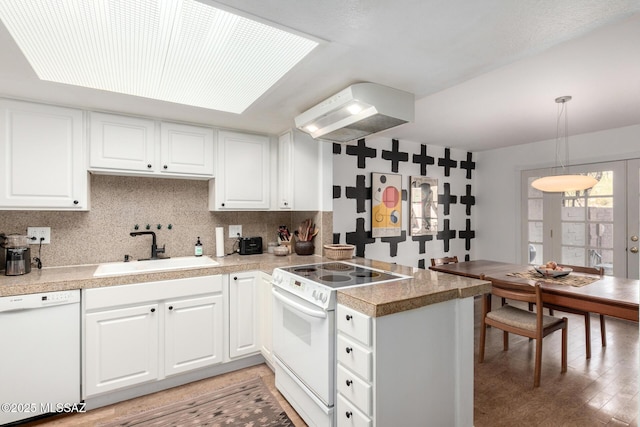 kitchen featuring white appliances, pendant lighting, white cabinets, and sink